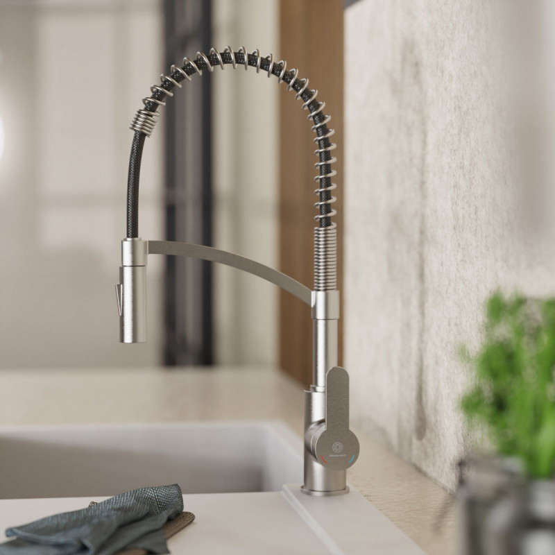 Küchenarmatur aus Edelstahl mit flexiblem Federhals und Ausziehbrause über Spülbecken.