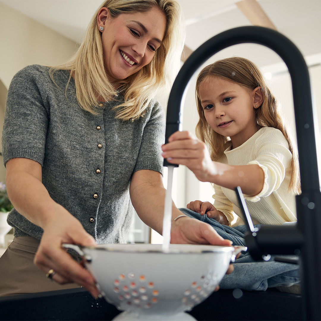 Mother and daughter wash something off