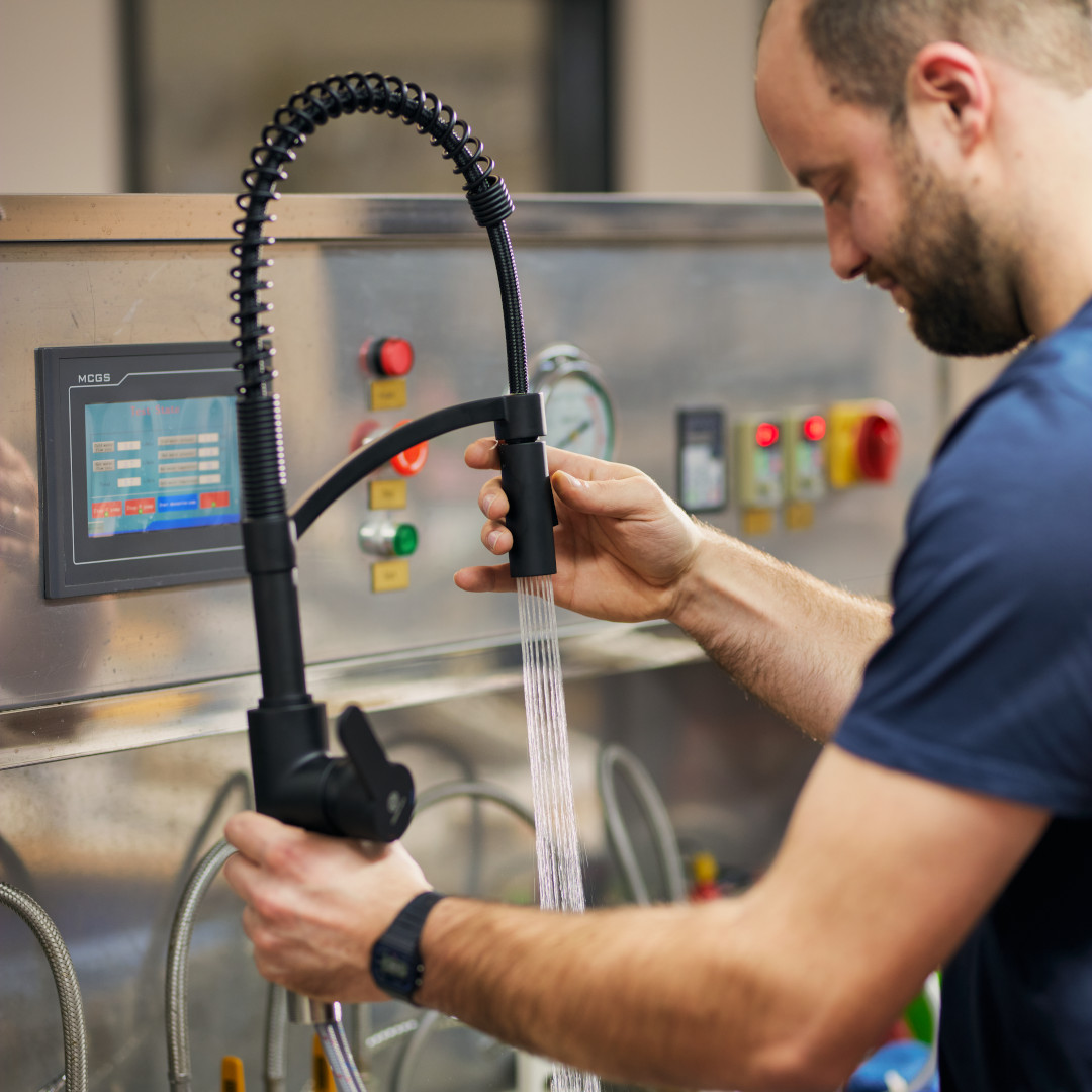 Employee checks a black kitchen faucet