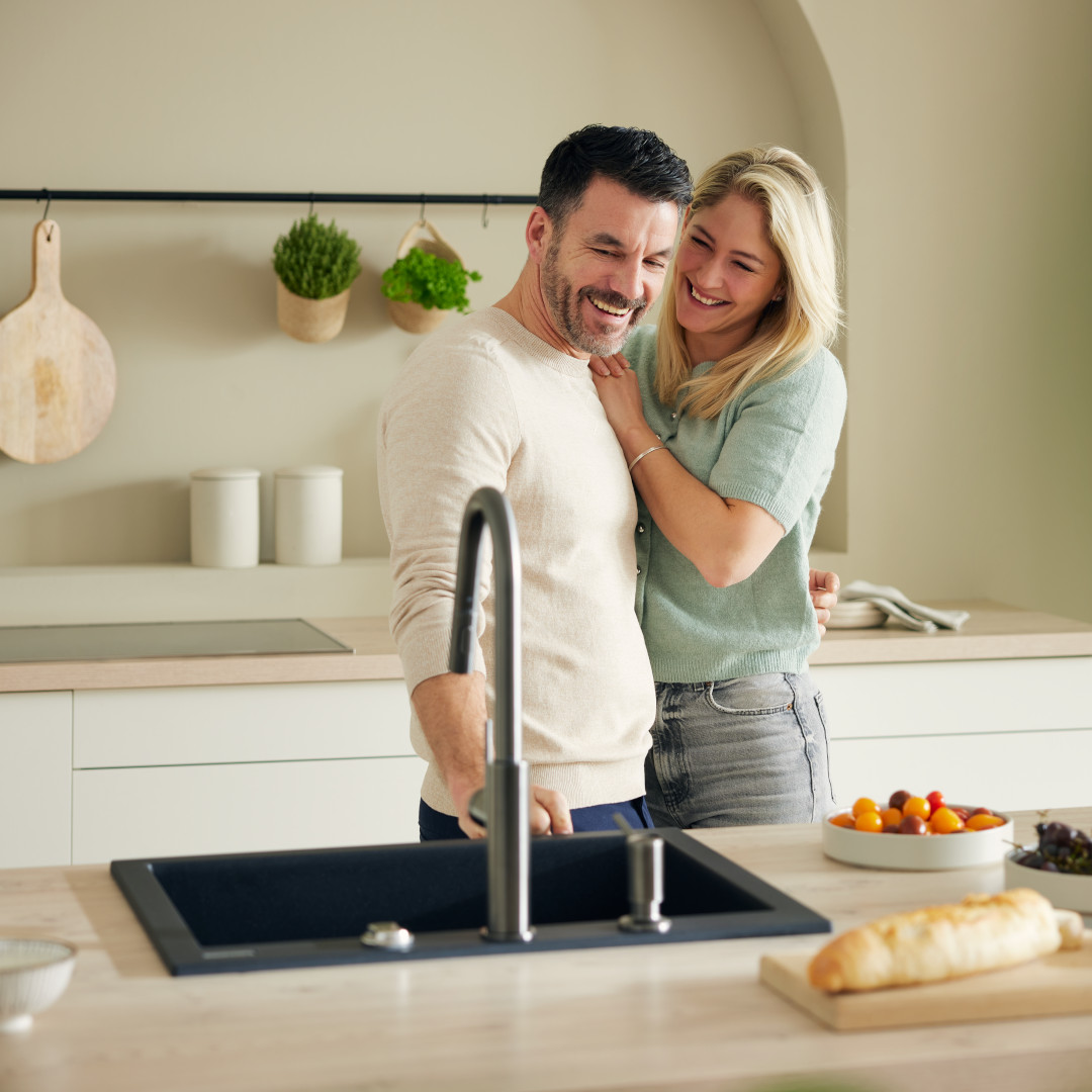 Couple standing in modern bright kitchen